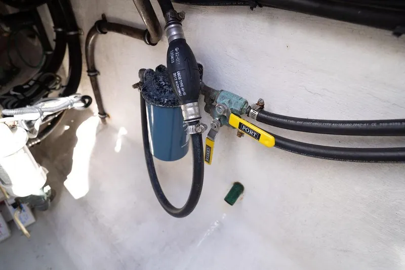 Slide: The Image of Engine compartment of 2013 Contender 32 ST with fuel lines and filter system. - 50