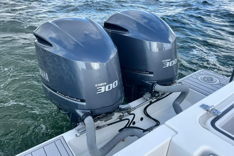 Slide: The Image of Twin Yamaha 300 outboard engines on a 2013 Contender 32 ST boat in water. - 58