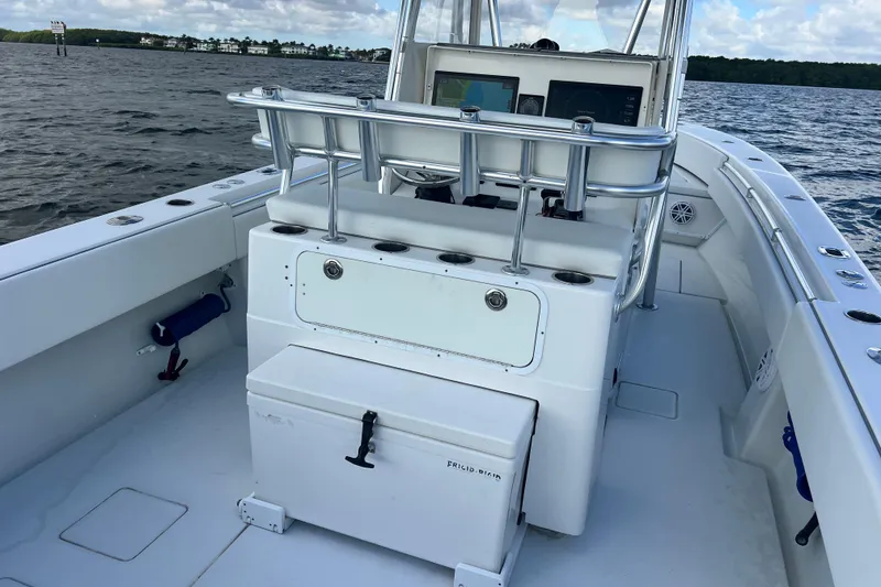 Slide: The Image of 2013 Contender 32 ST boat interior with console and seating, on calm waters. - 59