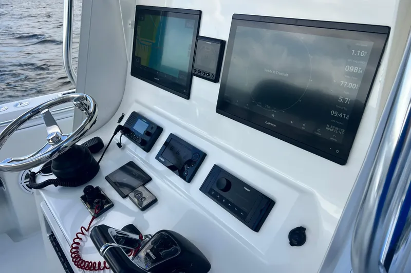 Slide: The Image of Control panel of 2013 Contender 32 ST boat with navigation screens and steering wheel. - 60