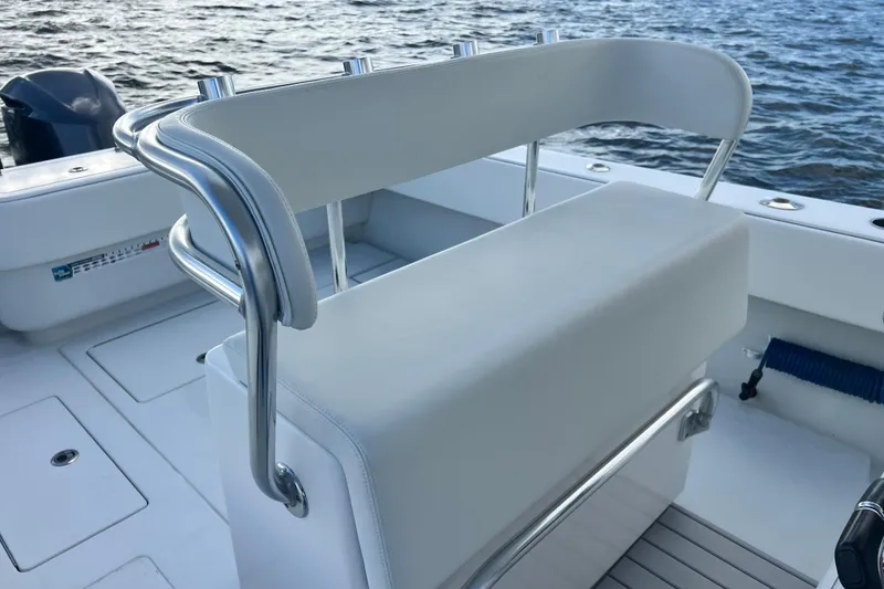 Slide: The Image of 2013 Contender 32 ST boat with white seating and stainless steel railings on the water. - 65