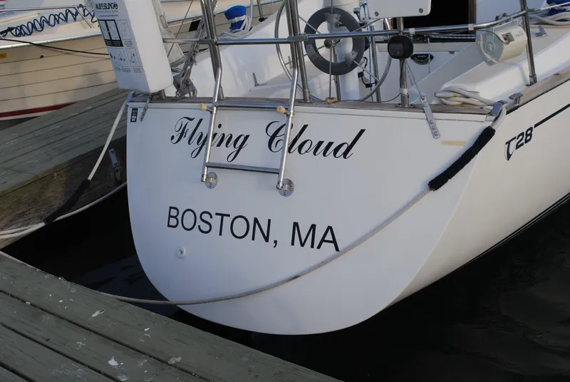 Slide: The Image of Sailing yacht "Flying Cloud" Tartan 28, 1988 model, on open sea with American flag. - 3