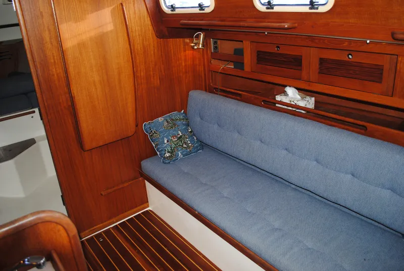 Slide: The Image of Interior of a 1988 Tartan 28 sailboat with blue cushions. - 31