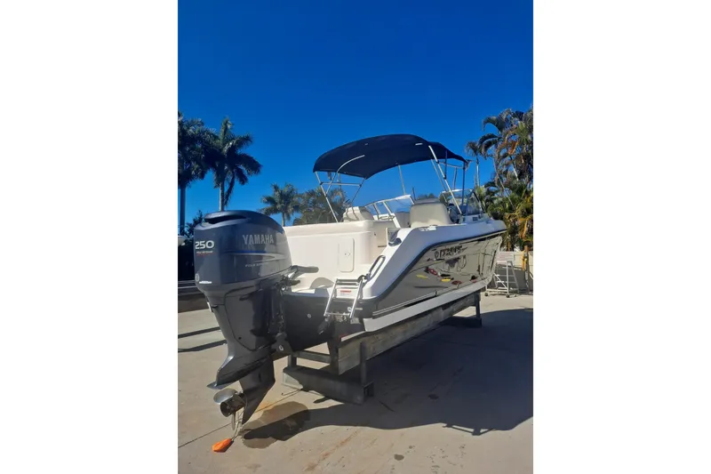 Slide: The Image of 2008 Century 2350 Dual Console boat with Yamaha 250 engine, parked outdoors. - 3