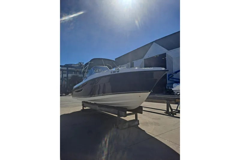 Slide: The Image of 2008 Century 2350 Dual Console boat on display in a sunny marina setting. - 4