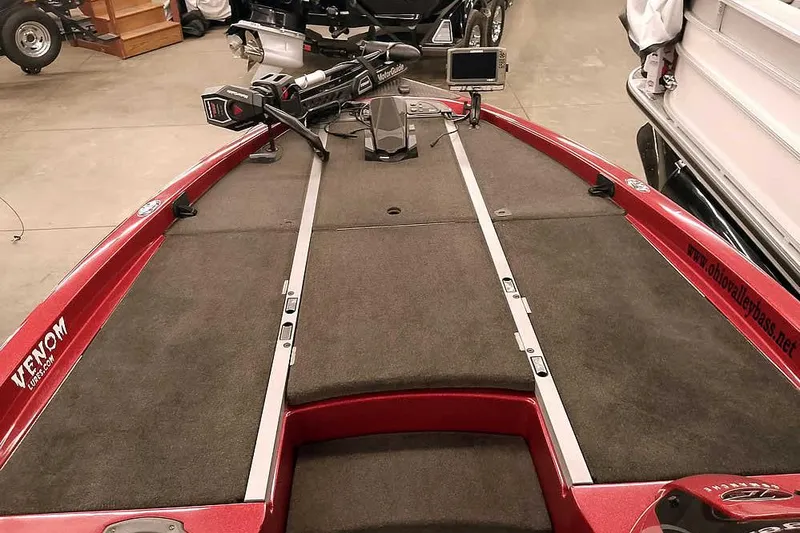 Slide: The Image of 2005 Ranger Z20 Comanche bass boat interior with trolling motor and carpeted deck. - 16