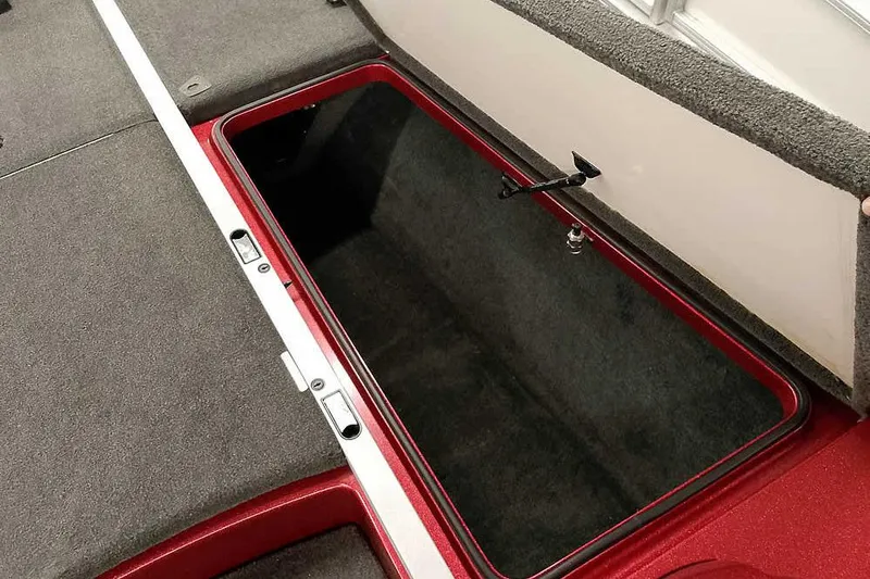 Slide: The Image of Open storage compartment in 2005 Ranger Z20 Comanche boat, featuring carpeted interior and red trim. - 17
