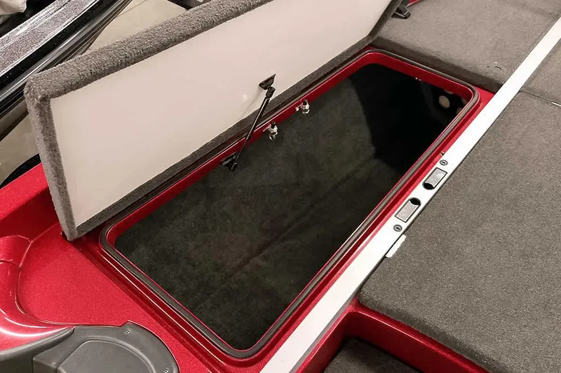Slide: The Image of Open storage compartment in 2005 Ranger Z20 Comanche boat, featuring red and gray interior. - 18