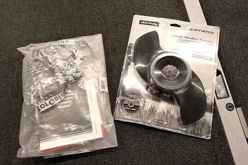 Slide: The Image of 2005 Ranger Z20 Comanche manuals and MotorGuide Katana propeller on carpeted floor. - 19