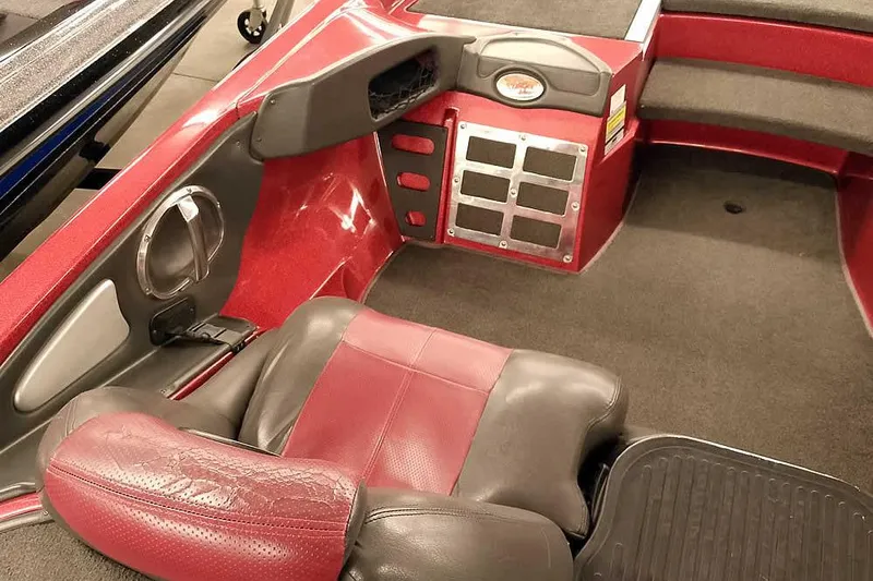 Slide: The Image of 2005 Ranger Z20 Comanche boat interior with red and black seating and dashboard. - 24
