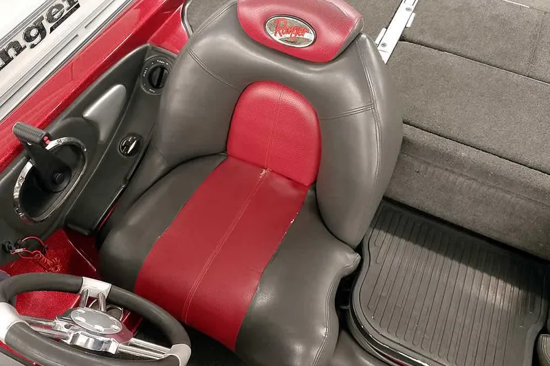 Slide: The Image of 2005 Ranger Z20 Comanche boat interior with red and gray seat and steering wheel. - 27
