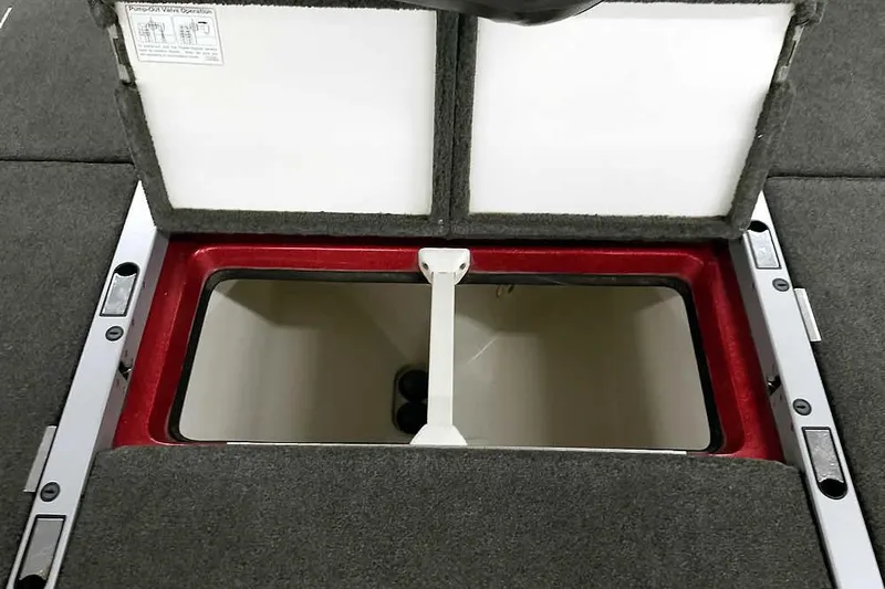 Slide: The Image of Open storage compartment in 2005 Ranger Z20 Comanche boat, featuring red trim and gray carpet. - 33