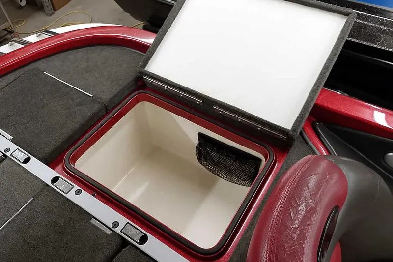 Slide: The Image of Open storage compartment in 2005 Ranger Z20 Comanche boat, featuring red and gray interior. - 34