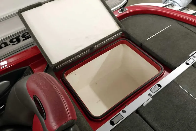 Slide: The Image of 2005 Ranger Z20 Comanche boat storage compartment with open lid, red and gray interior. - 35