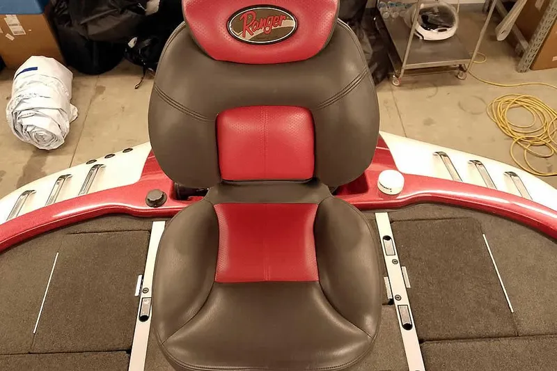 Slide: The Image of 2005 Ranger Z20 Comanche boat seat with red and gray upholstery in a garage setting. - 36