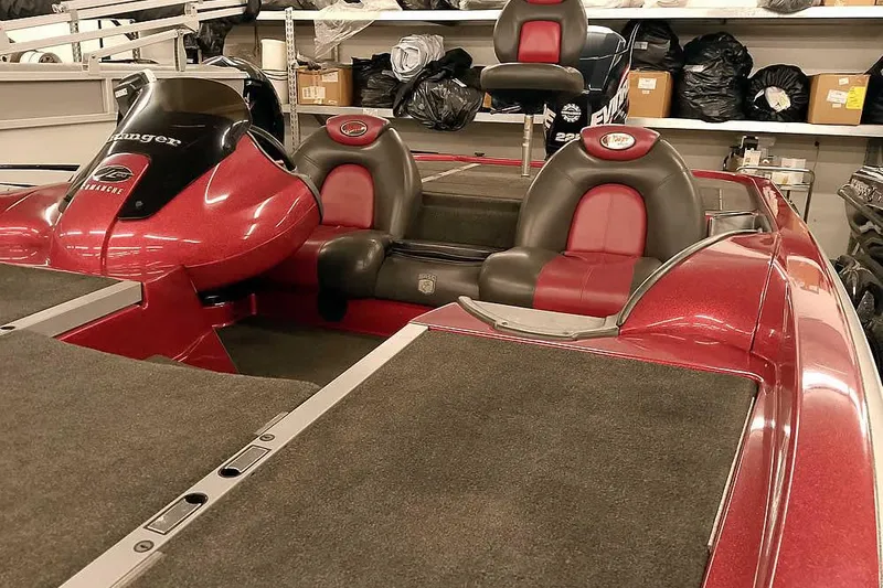Slide: The Image of 2005 Ranger Z20 Comanche boat interior with red and black seating in a showroom. - 9