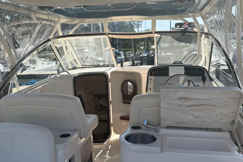 Slide: The Image of 2021 Grady-White Freedom 307 boat interior with helm, seating, and navigation equipment. - 14