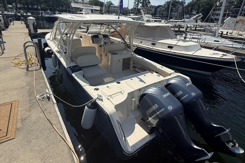 Slide: The Image of 2021 Grady-White Freedom 307 boat docked with twin Yamaha 300 engines. - 2