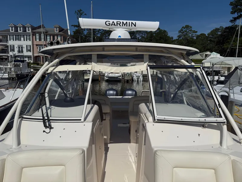 Slide: The Image of 2021 Grady-White Freedom 307 boat docked at marina with Garmin equipment. - 3