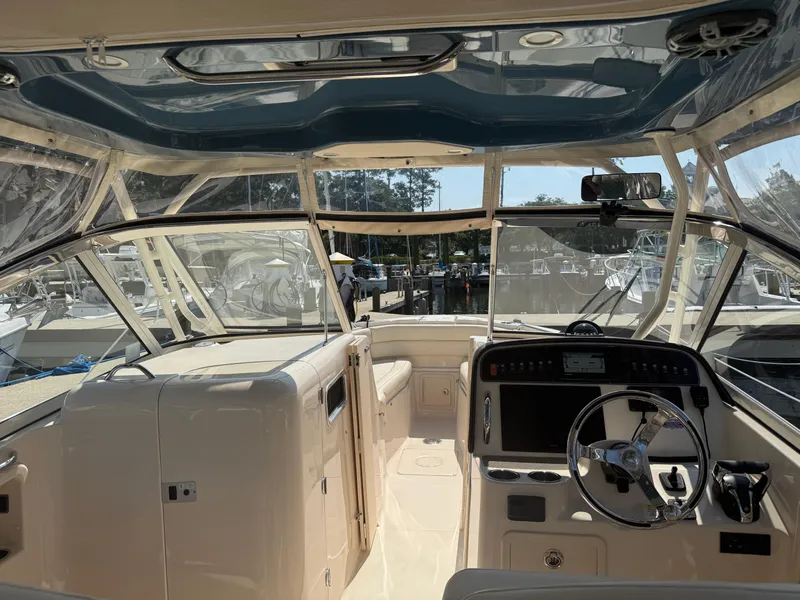 Slide: The Image of 2021 Grady-White Freedom 307 boat interior with helm, steering wheel, and seating. - 4