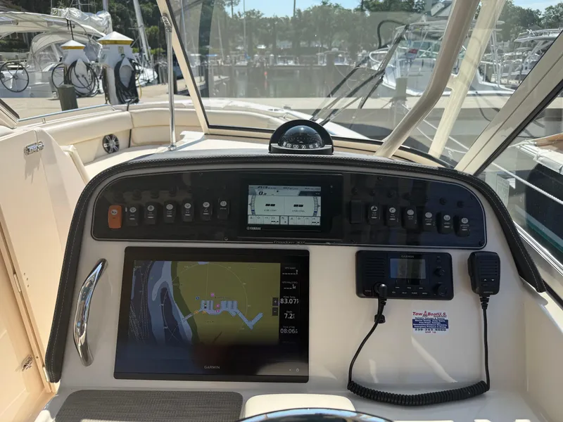 Slide: The Image of 2021 Grady-White Freedom 307 boat dashboard with navigation and control systems. - 6