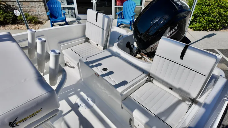 Slide: The Image of 2025 Bayliner T18 Limited Edition boat interior with white seating and Mercury outboard motor. - 10