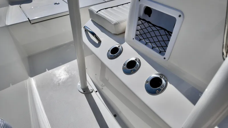 Slide: The Image of 2025 Bayliner T18 Limited Edition boat interior with rod holders and storage compartment. - 6