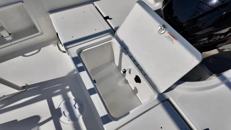 Slide: The Image of 2025 Bayliner T18 Limited Edition boat storage compartment open on deck. - 9