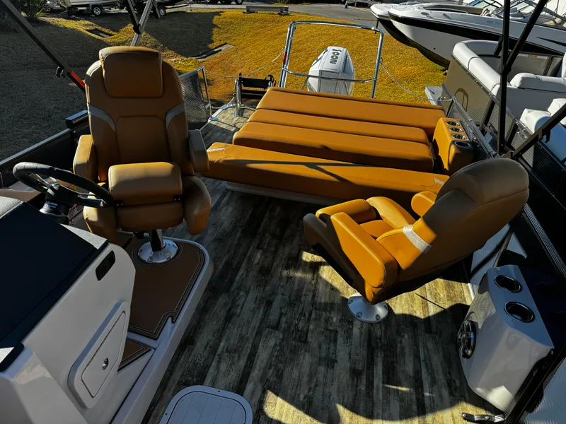 Slide: The Image of 2024 Crest Caribbean LX 230 boat interior with tan seating and cup holders. - 10