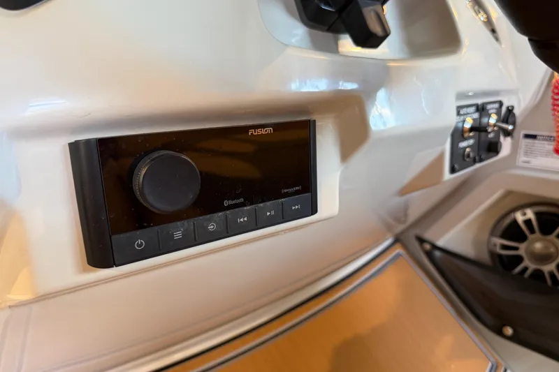 Slide: The Image of 2024 Crest Caribbean LX 230 dashboard with Fusion audio system and controls. - 14