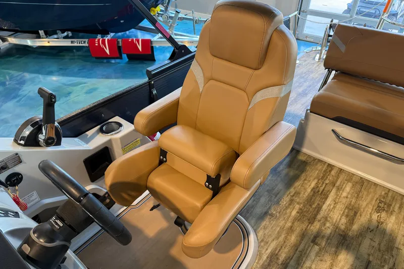 Slide: The Image of Captain's chair in 2024 Crest Caribbean LX 230 boat interior. - 15