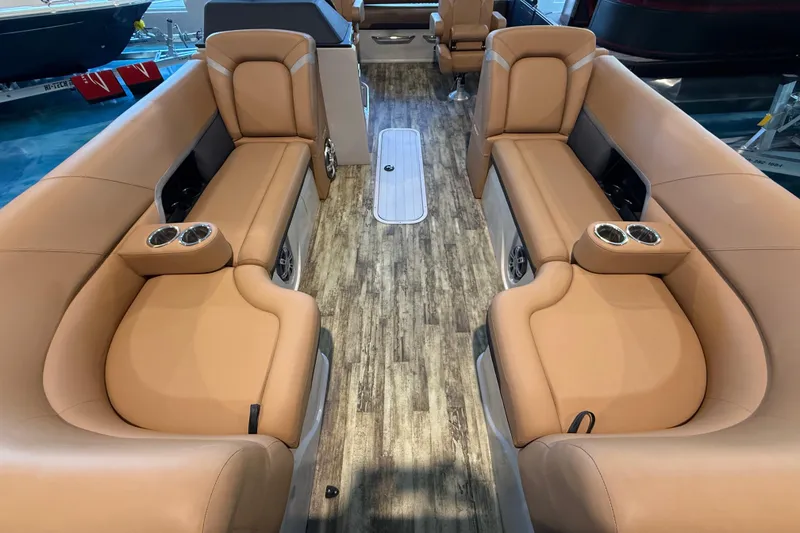 Slide: The Image of Luxurious interior of 2024 Crest Caribbean LX 230 pontoon boat with tan seating and wood flooring. - 18