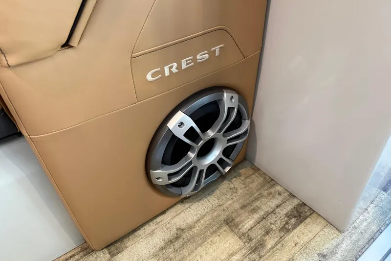 Slide: The Image of 2024 Crest Caribbean LX 230 interior with speaker and tan upholstery. - 19