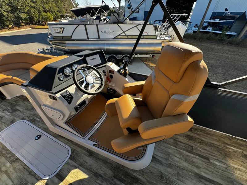 Slide: The Image of 2024 Crest Caribbean LX 230 boat interior with tan seating and cup holders. - 9