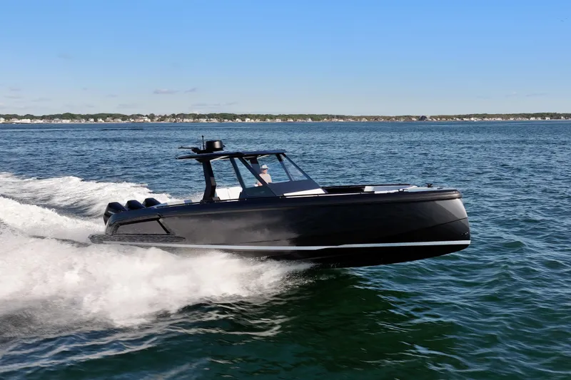 Slide: The Image of 2024 Vanquish Yachts VQ40 cruising on open water, showcasing sleek design and performance. - 10