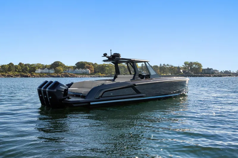 Slide: The Image of 2024 Vanquish Yachts VQ40 luxury boat on serene water with scenic background. - 14