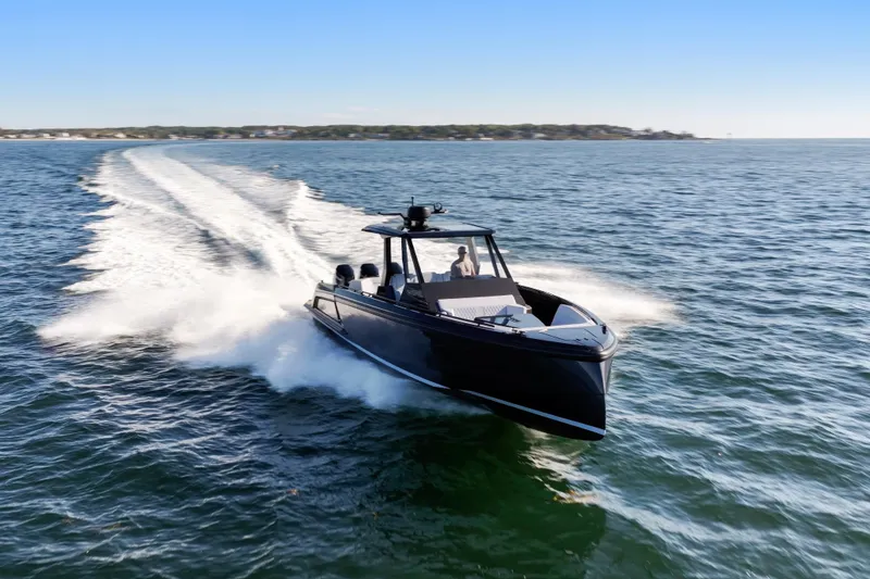 Slide: The Image of 2024 Vanquish Yachts VQ40 cruising swiftly on open water. - 2