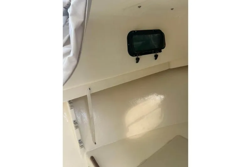 Slide: The Image of Interior view of 2001 Parker 2320 Sport Cabin boat, featuring a small window. - 15