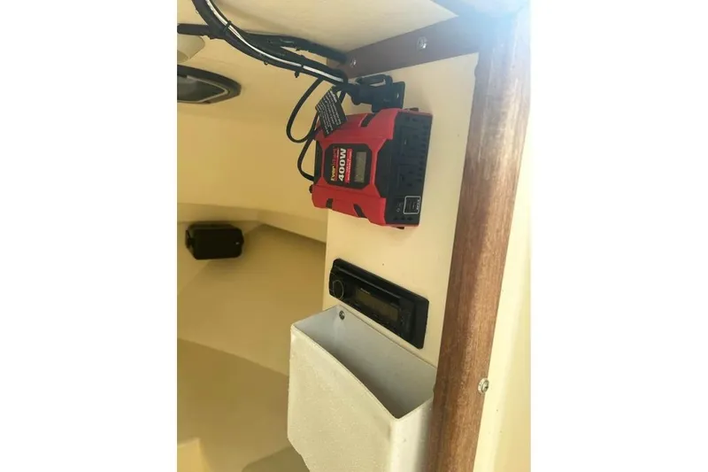 Slide: The Image of Interior of 2001 Parker 2320 Sport Cabin with mounted power inverter and storage compartment. - 17