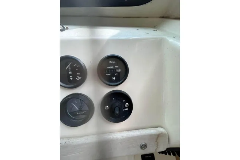 Slide: The Image of Dashboard of a 2001 Parker 2320 Sport Cabin boat with gauges and controls. - 19