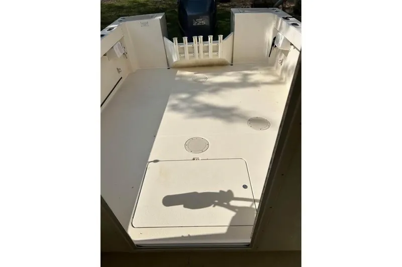 Slide: The Image of 2001 Parker 2320 Sport Cabin boat deck with storage compartments and rod holders. - 20