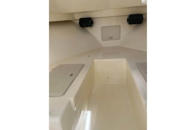 Slide: The Image of Interior of a 2001 Parker 2320 Sport Cabin boat, featuring storage compartments. - 3
