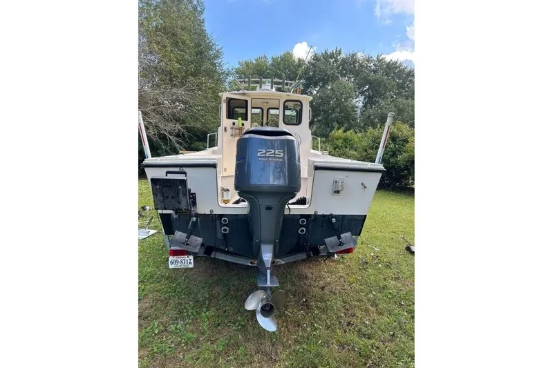 Slide: The Image of Rear view of a 2001 Parker 2320 Sport Cabin boat with outboard motor. - 4