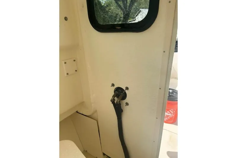 Slide: The Image of Interior view of a 2001 Parker 2320 Sport Cabin boat, showing a window and cable. - 7