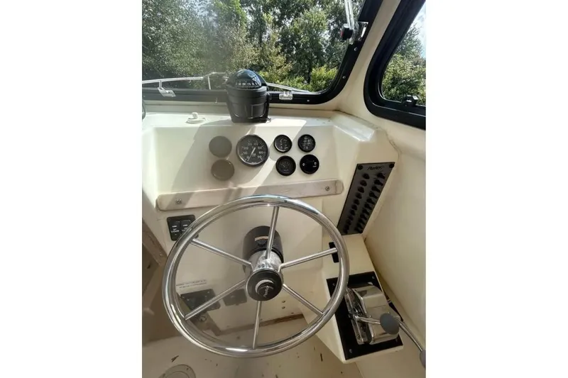 Slide: The Image of Steering console of a 2001 Parker 2320 Sport Cabin boat with gauges and controls. - 8