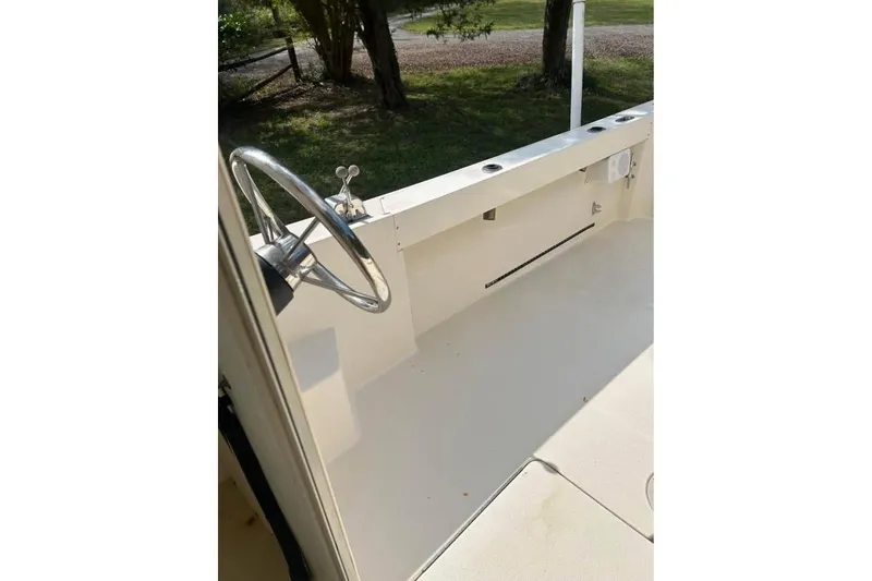 Slide: The Image of 2001 Parker 2320 Sport Cabin boat interior with steering wheel and open deck. - 11