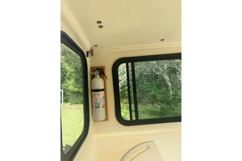 Slide: The Image of Interior of 2001 Parker 2320 Sport Cabin with fire extinguisher and window view. - 12