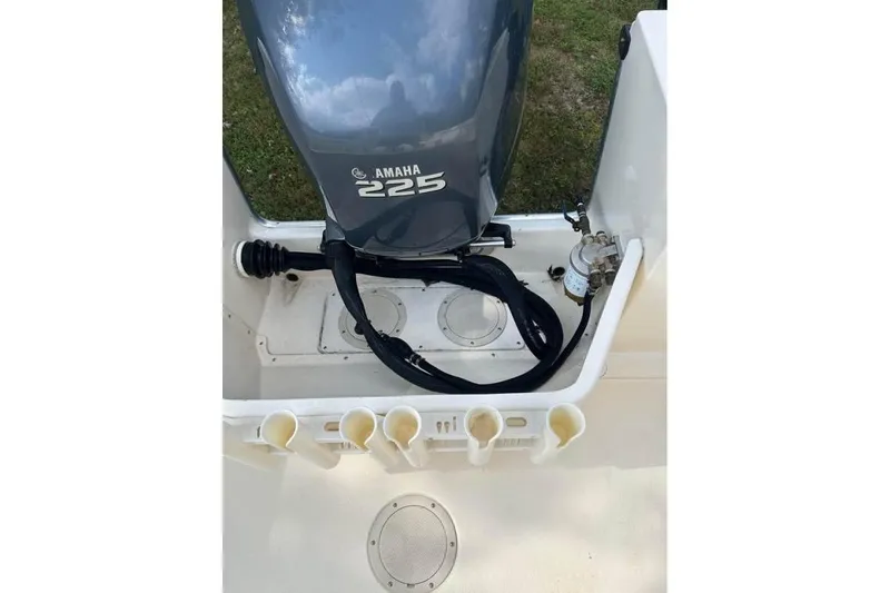 Slide: The Image of Parker 2320 Sport Cabin 2001 with Yamaha 225 engine, featuring rod holders and fuel filter. - 16