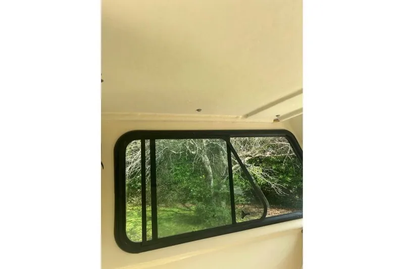 Slide: The Image of Interior view of 2001 Parker 2320 Sport Cabin window with outdoor greenery. - 5
