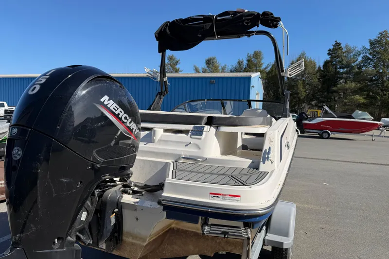 Slide: The Image of 2021 Bayliner VR5 Bowrider OB with Mercury outboard motor, parked outdoors. - 2
